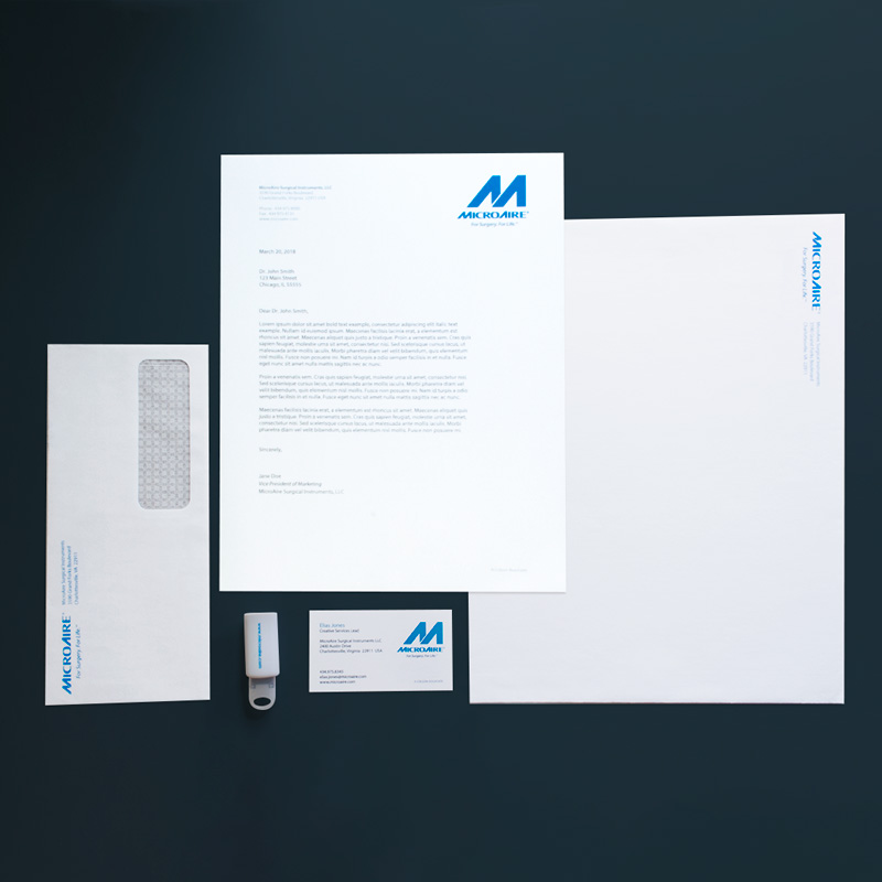 photo of designed medical device company stationery letterhead, business card, flash drive and envelopes